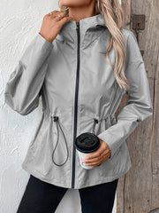 Gray utility jacket with cinched waist, drawstring detail, and hood.