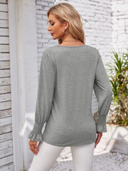 Gray blouson sleeve top with smocked cuffs and V-neck detail.