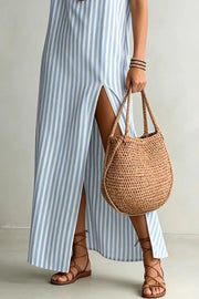 Light blue striped maxi dress with V-neck and high slit, worn with gladiator sandals.