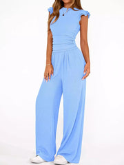 Sky blue maternity two-piece ensemble with ruffled cap sleeves, ruched waist, and wide-leg pants.