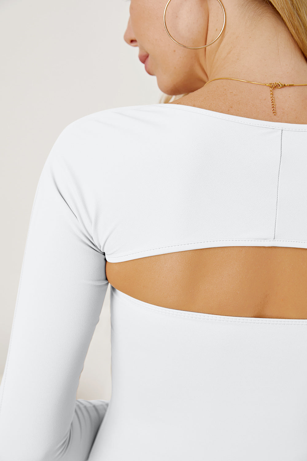 White long sleeve bodysuit with open back detail