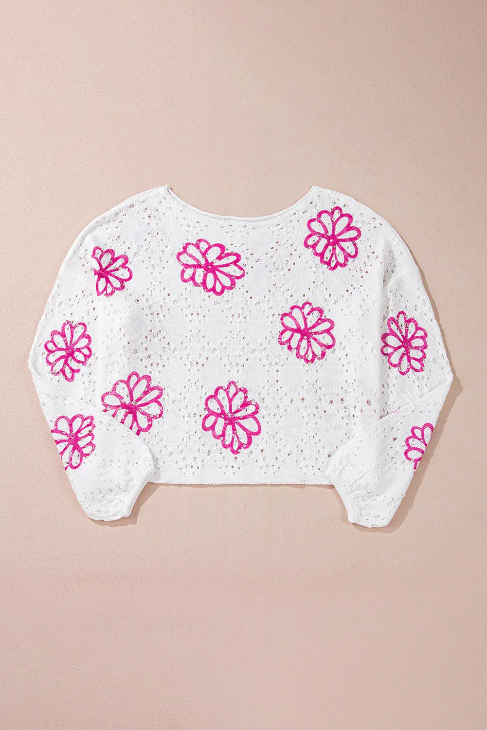 White eyelet knit pullover with pink floral embroidery and long sleeves.