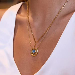 Elegant 18k gold-plated layered necklace with horseshoe pendant and blue stone.