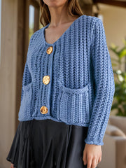 Light blue chunky knit cardigan with statement buttons and pockets
