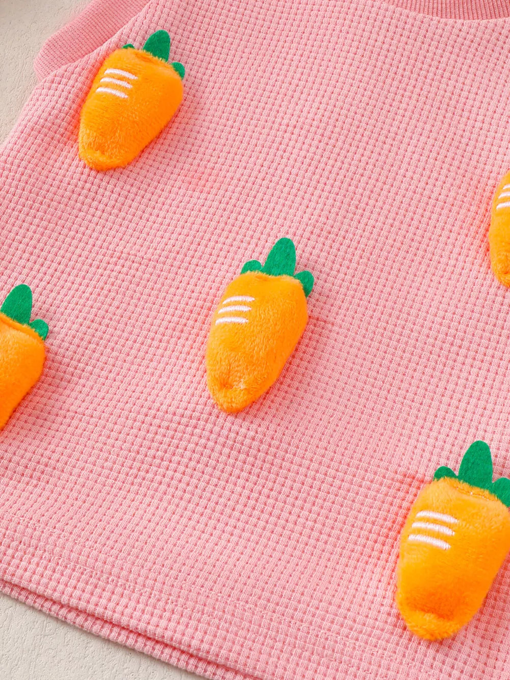 Pink waffle knit baby set with allover 3D carrot appliqués.