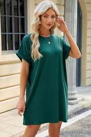 Dark green cuffed sleeve pocket dress with crew neck and relaxed fit.