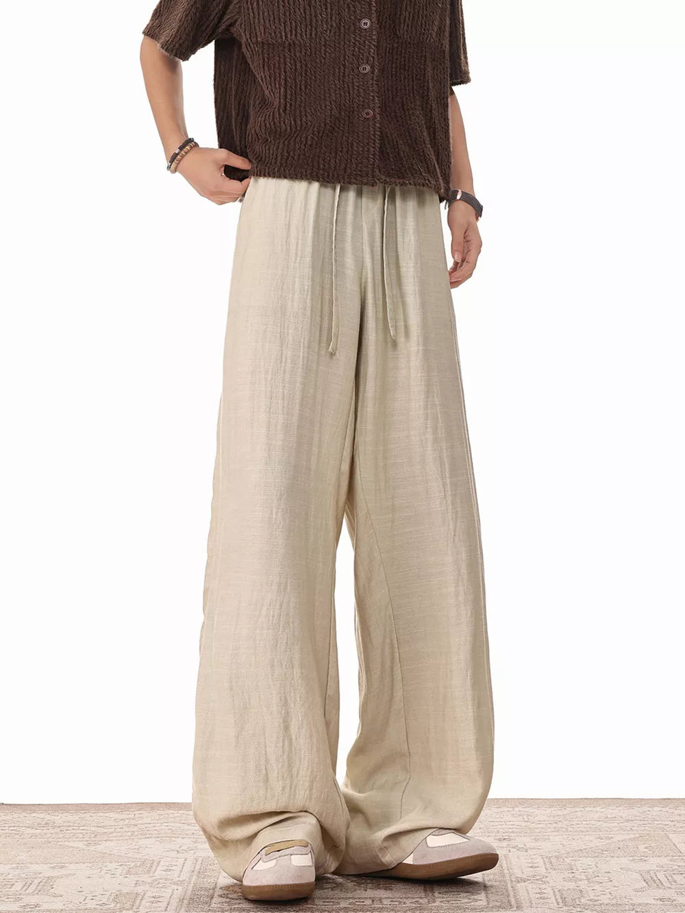 Khaki relaxed fit drawstring sweatpants with wide legs and a comfortable casual style.