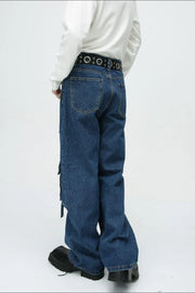 Medium wash denim cargo pants with buckle strap details and a wide leg cut.