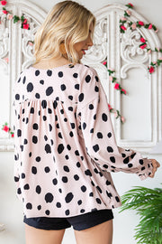 Beige polka dot blouse with balloon sleeves and ruffled cuffs.