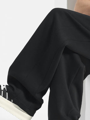 Men's black casual drawstring sweatpants with a relaxed fit and visible stitching detail.