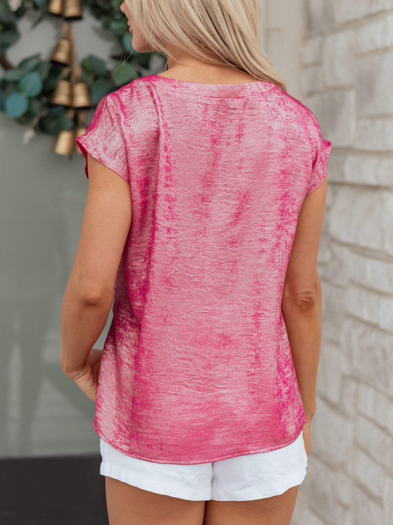 Hot pink metallic tee with cap sleeves and round neck, made of polyester and spandex.