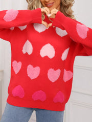 Red fuzzy knit sweater with pink and white heart pattern.