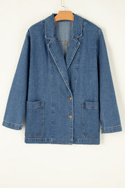 Medium wash denim double-breasted blazer with two button closure and flap pockets.