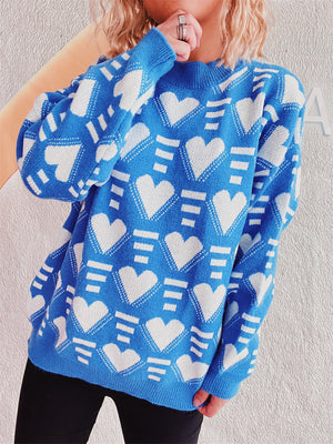 Blue acrylic knit jumper with allover white geometric heart pattern and crew neck.