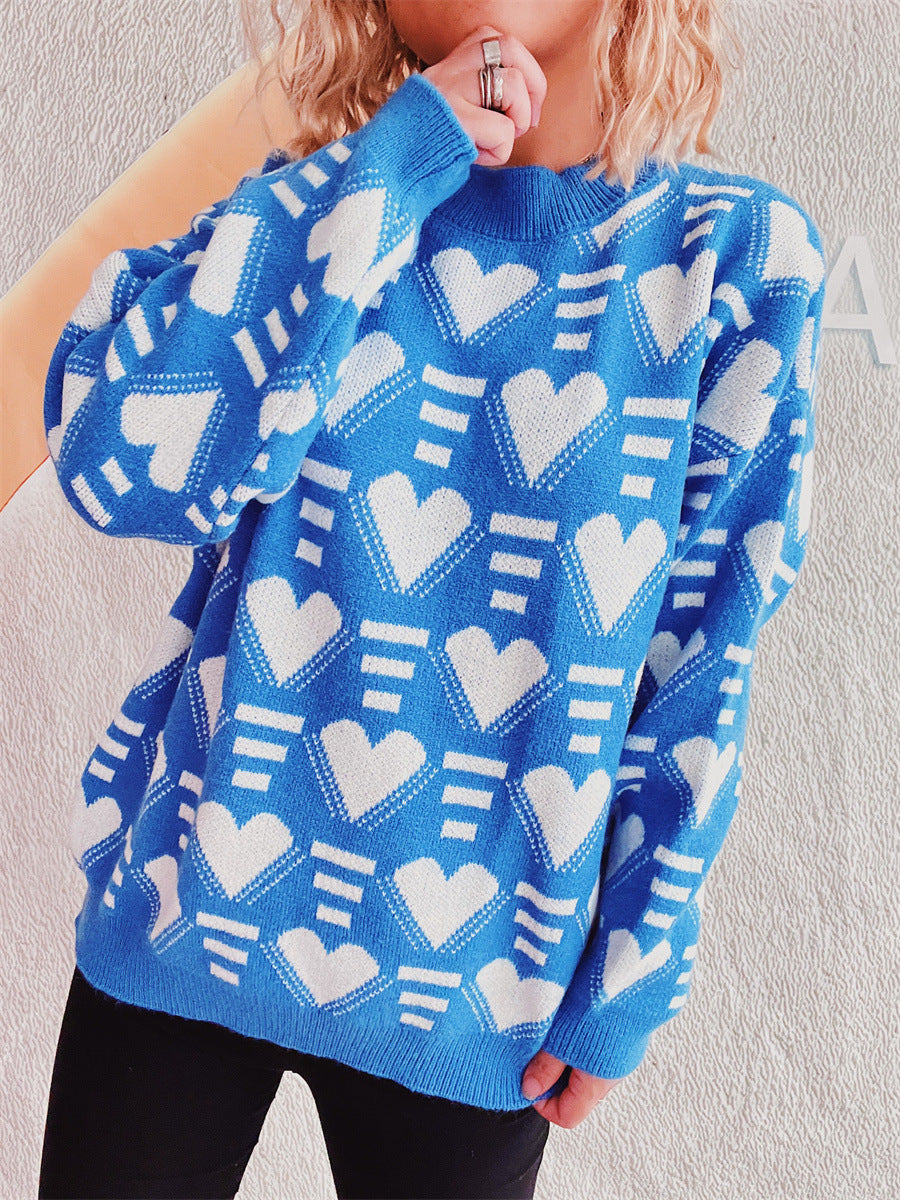 Blue acrylic knit jumper with allover white geometric heart pattern and crew neck.