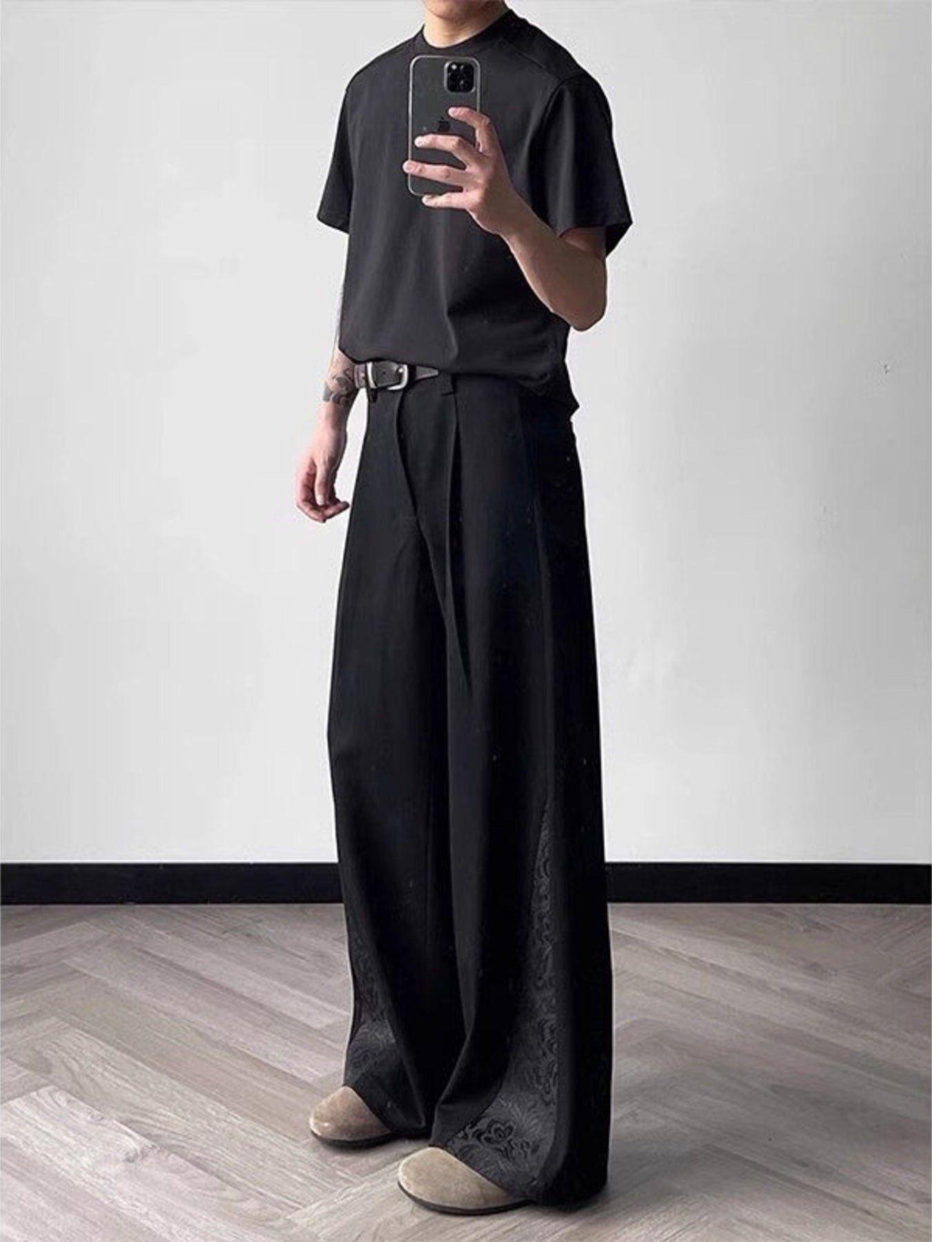 Men's black relaxed fit wide leg trousers with subtle jacquard detail on the hem.