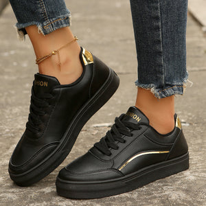 Black lace-up casual sneakers with gold accents and "Fashion" detail.
