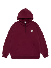 Maroon quarter-zip hoodie with a front pouch pocket and a small embroidered patch.