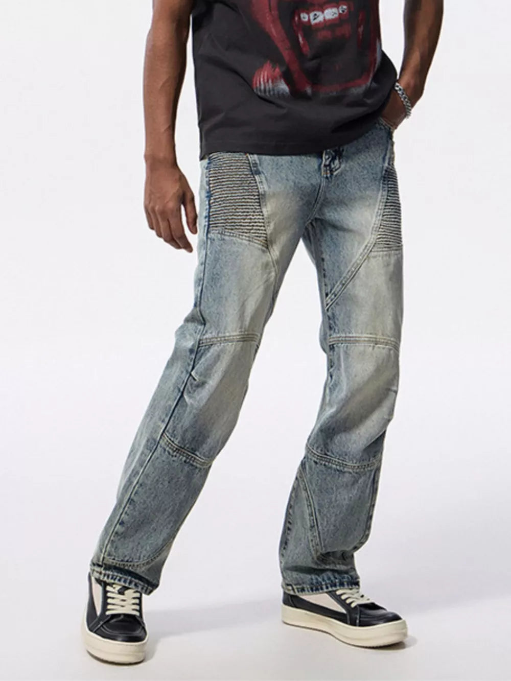 Men's light wash denim jeans with moto-inspired paneling and a wide-leg fit.