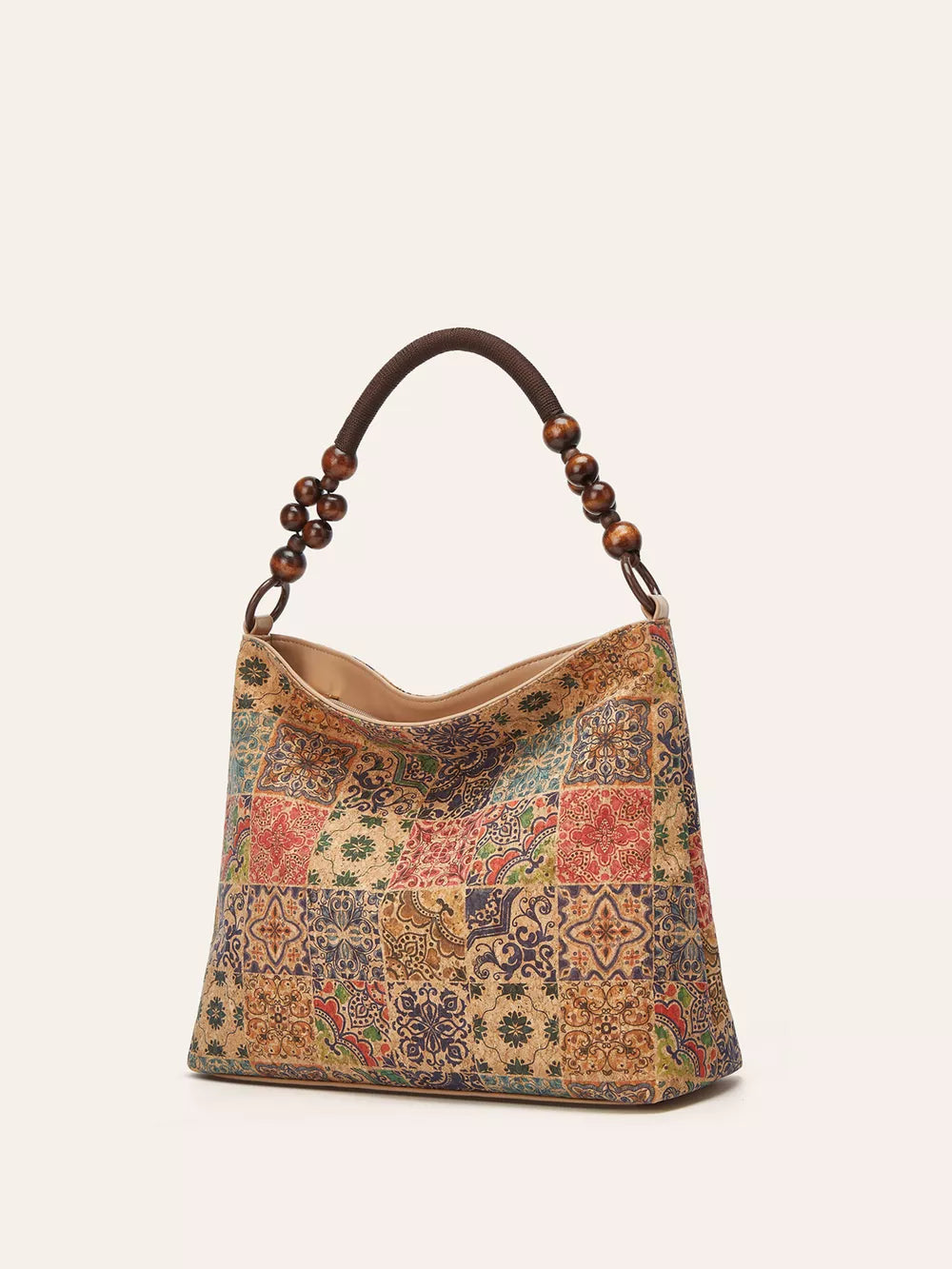 Vibrant bohemian hobo tote in brown with colorful geometric patchwork pattern and beaded strap.