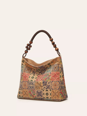 Vibrant bohemian hobo tote in brown with colorful geometric patchwork pattern and beaded strap.