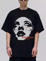 Black oversized graphic tee with a distressed face print and red text.