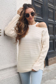 Ivory ribbed knit sweater with asymmetric shoulder detail and long sleeves.