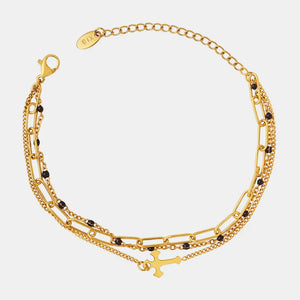 Gold layered chain and bead bracelet trio with cross charm