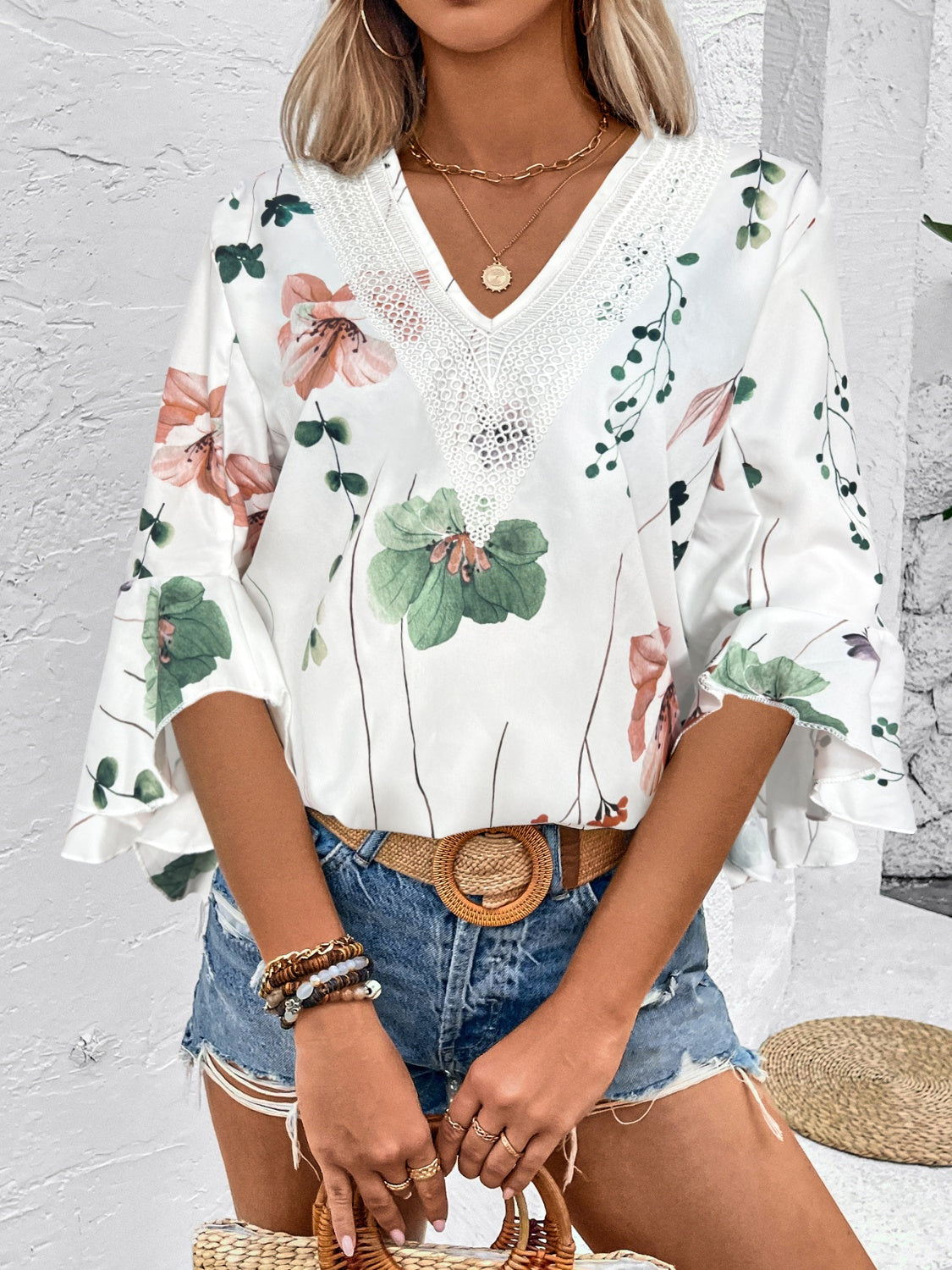 White floral bell sleeve blouse with lace trim neckline.