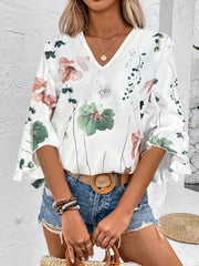 White floral bell sleeve blouse with lace trim neckline.