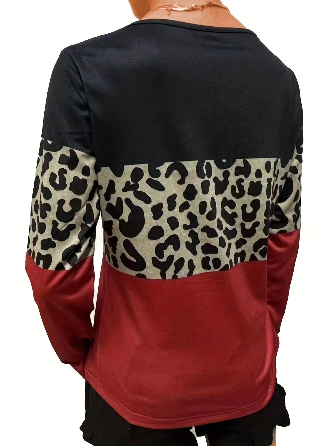 Long sleeve top with black, leopard print, and deep red color blocking.