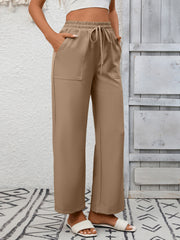 Khaki drawstring wide-leg pants with elastic waist and patch pockets.