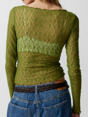 Olive green lace blouse with scalloped edges and long sleeves, worn over a bralette.