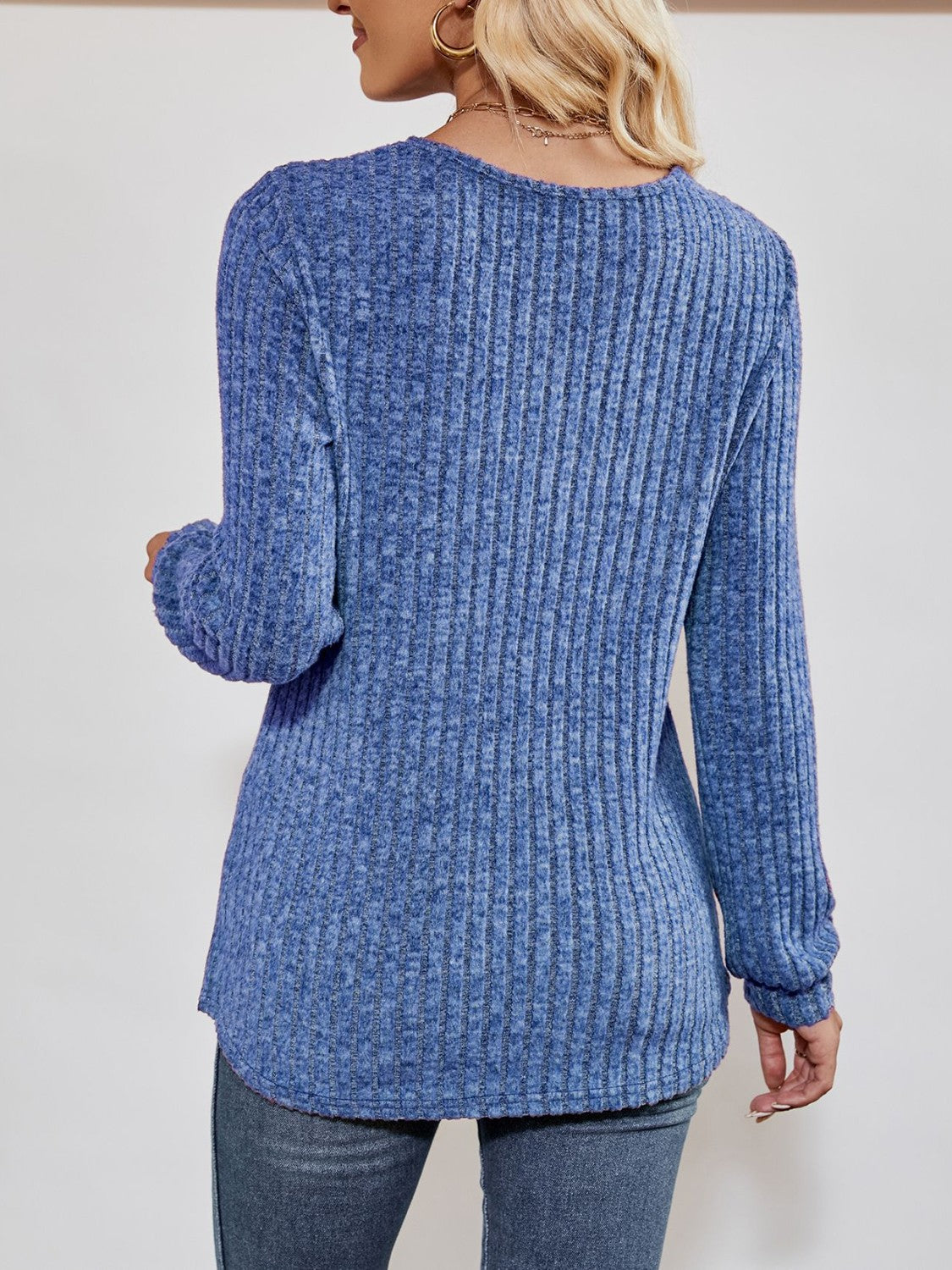 Cobalt blue textured ribbed V-neck pullover sweater with long sleeves.