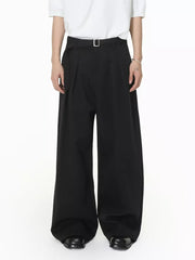 Black wide-leg pleated sweatpants with a belt and silver buckle.
