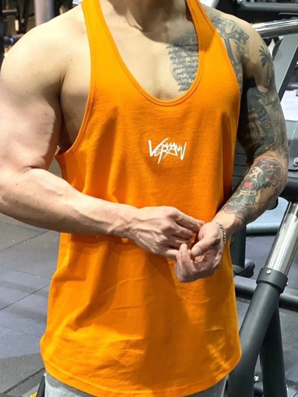 Tangerine performance racerback tank top with white graphic detail