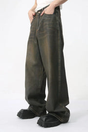 Faded oversized denim trousers in dark wash, featuring a relaxed fit and wide leg.