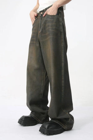 Faded oversized denim trousers in dark wash, featuring a relaxed fit and wide leg.