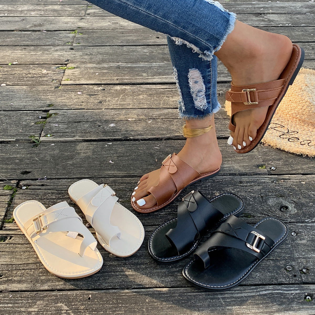 Chic toe loop flat sandals in black, beige, and brown with buckle detail.