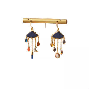 18K gold-plated dangle earrings with blue clouds and colorful charms, including moons and teardrop shapes.