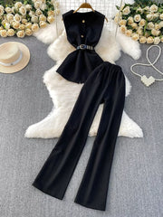Black belted two-piece set with sleeveless top and wide-leg pants.