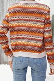 Geometric knit bomber jacket in orange with diamond and stripe patterns.