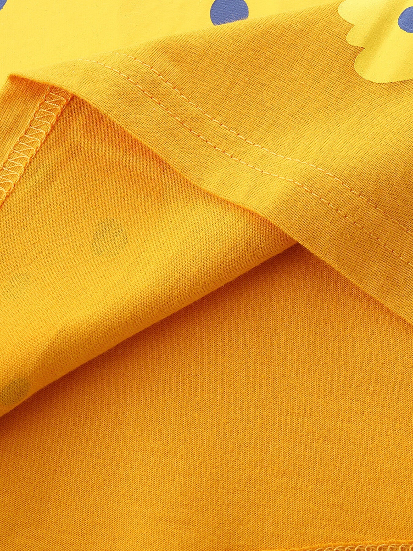 Yellow cotton toddler t-shirt with blue polka dot and leopard graphic detail.