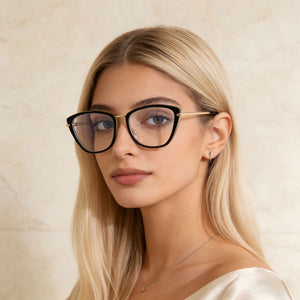 Black cat-eye glasses with gold metal accents and clear lenses.