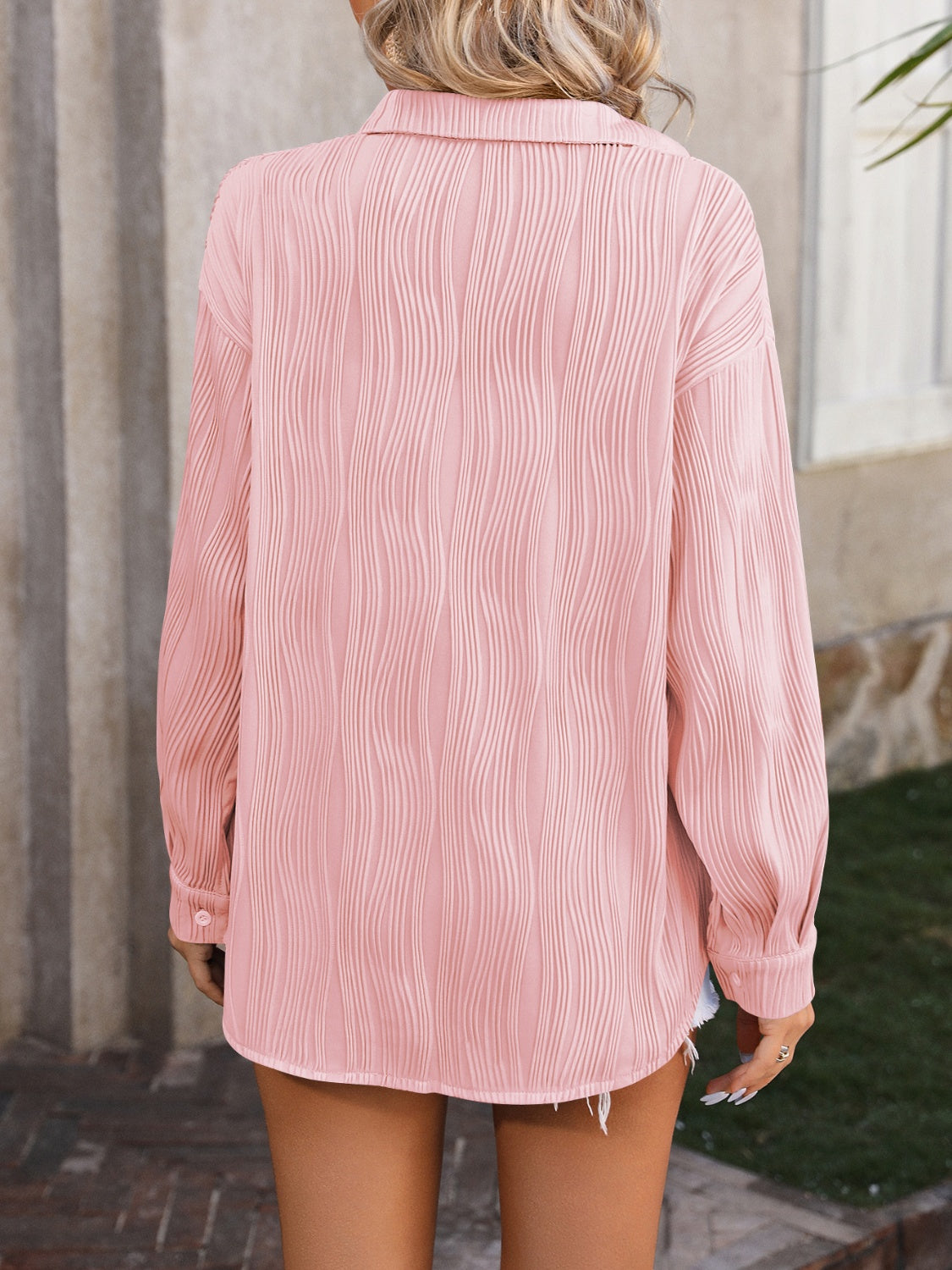 Textured pleated button-down shirt in blush pink with a relaxed fit.