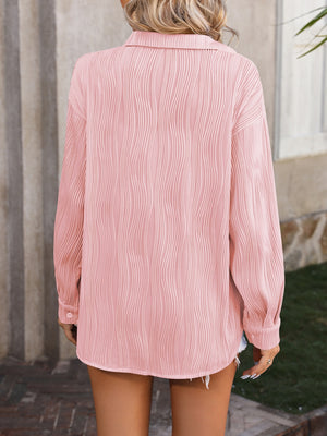 Textured pleated button-down shirt in blush pink with a relaxed fit.