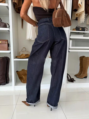 Dark blue denim wide-leg pants with cuffed hems and contrast stitching.