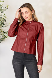 Red orange faux leather biker jacket with zip front and mock neck.
