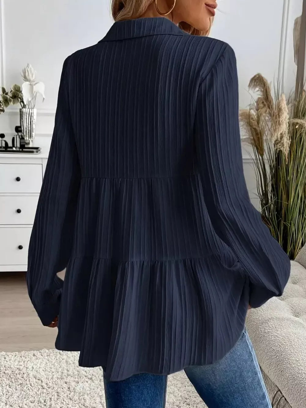 Dark blue textured tiered button-down shirt with a crinkled fabric and collared neckline.