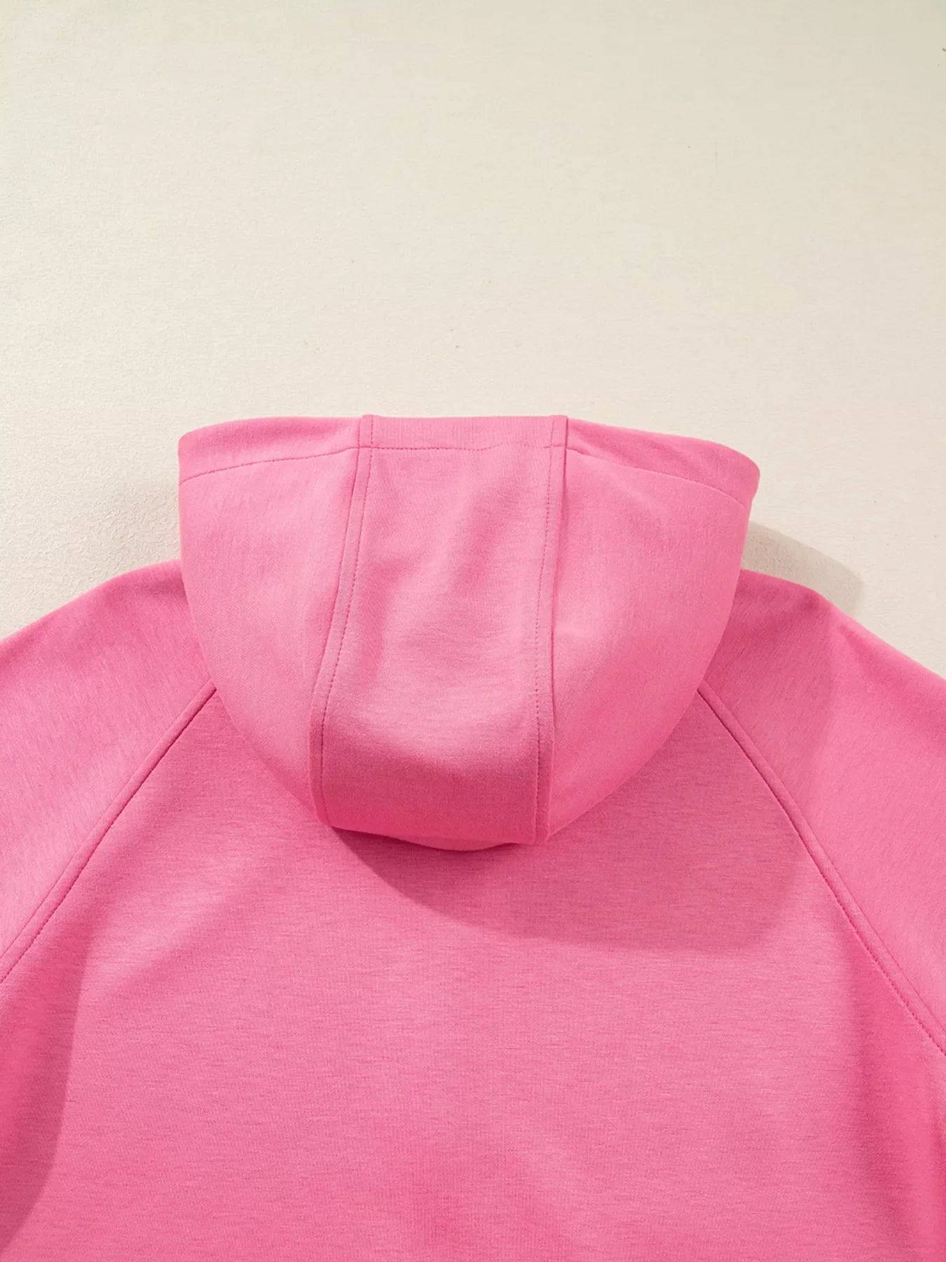 Dusty pink relaxed fit zip-up hoodie with a drawstring hood detail